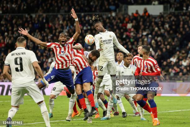 Atletico Madrid's French midfielder Geoffrey Kondogbia and Real Madrid's French midfielder Eduardo Camavinga jump for the ball during the Copa del...