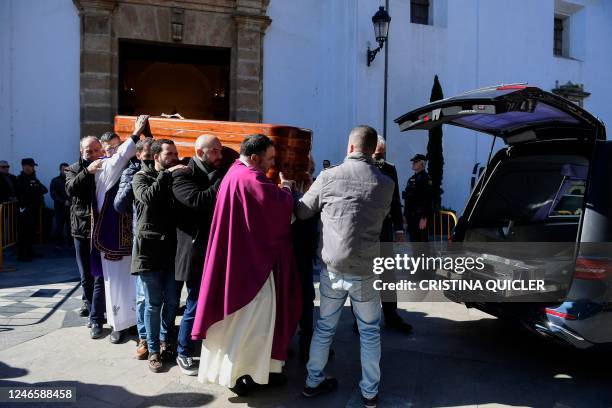 Pallbearers carry the casket of late sacristan Diego Valencia into a hearse after a funeral mass at the Nuestra Senora de La Palma church on Alta...