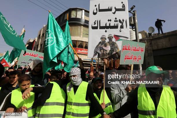 Protesters in the Jordanian capital Amman raise the national flag as well as flags of the Muslim Brotherhood, as they rally in support of...