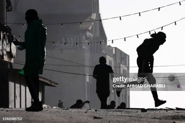 Palestinian demonstrators clash with Israeli forces in the West Bank town of Al-Ram on January 27 a day after a deadly Israeli raid on the Jenin...