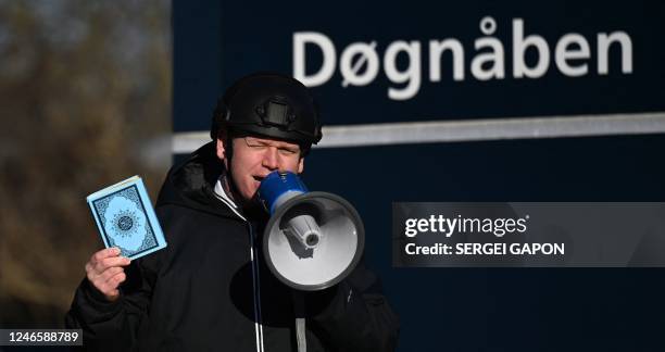 Far-right politician Rasmus Paludan holds up a Koran copy as he speaks in front of a mosque in Copenhagen, on January 27, 2023. - Turkey summoned...