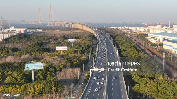 Aerial photo taken on Jan. 27, 2023 shows a large number of vehicles passing the Sutong Bridge slowly on the G15 highway from north to south in...