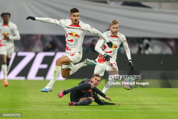 Andre Silva of RB Leipzig, Leon Goretzka of Bayern Muenchen and Konrad Laimer of RB Leipzig battle for the ball during the Bundesliga match between...