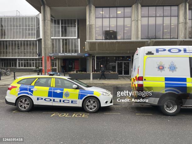 Police vehicles are seen at Hove Town Hall amid a recent revelation of dozens of asylum-seeking children in Britain missing from hotels run by the...