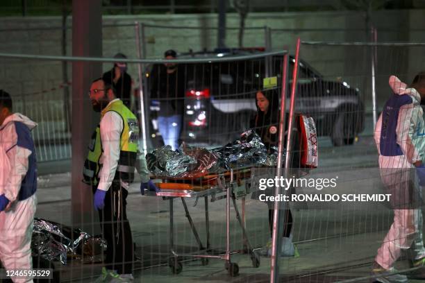 Israeli emergency service personnel transport casualties at the site of a reported attack in a settler neighbourhood of Israeli-annexed east...