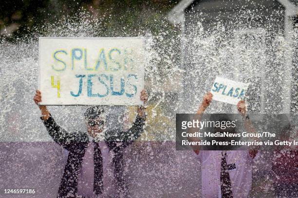 Ontario, CA While holding splash signs, missionaries and members of the Church of Jesus Christ of Latter-day Saints, Bennet Lim left, and Jack Bodmer...