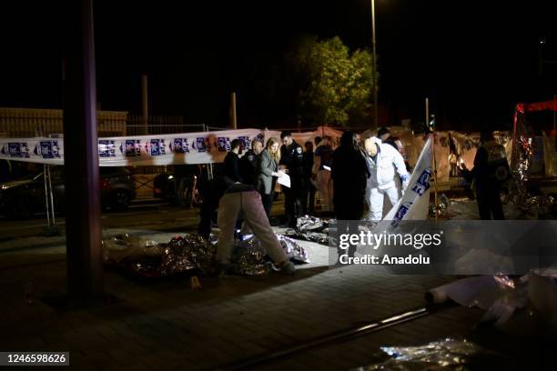 Israeli police investigate the crime scene after 7 people were killed in an armed attack in Jewish settlement at East Jerusalem on January 27, 2023.