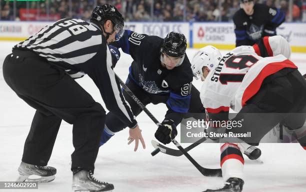Linesman Ryan Gibbons drops the puck for a face off with Toronto Maple Leafs center John Tavares versus Ottawa Senators left wing Tim Stützle as the...