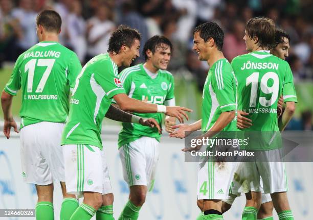 Mario Mandzukic of Wolfsburg celebrates with his team mate Marcel Schaefer after scoring his team's second goalduring the Bundesliga match between...