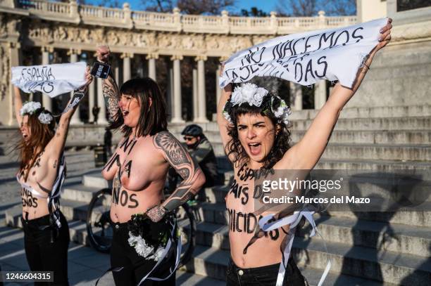 Activists of feminist group FEMEN with their bare chests painted with messages protesting against the increase in gender-based murder of women...