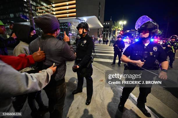 Protesters face off with a line of police officers during a rally against the fatal police assault of Tyre Nichols outside the LAPD headquarters, in...