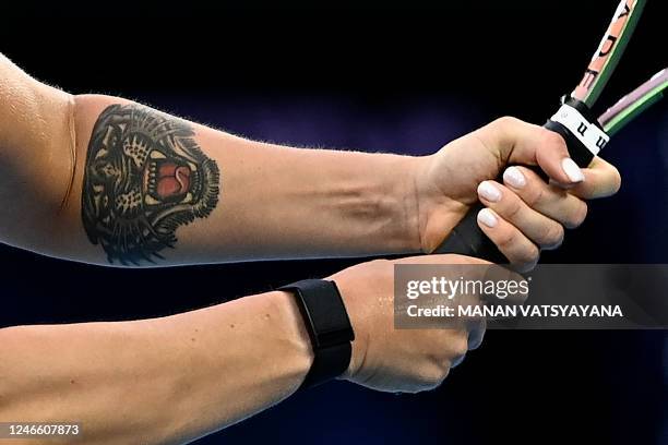 Tiger tattoo is seen on the arm of Belarus' Aryna Sabalenka as he hits a return against Kazakhstan's Elena Rybakina during their women's singles...