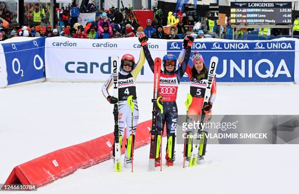 Second placed Germany's Lena Duerr, winner US' Mikaela Shiffrin and third placed Switzerland's Wendy Holdener celebrate after the women's slalom...