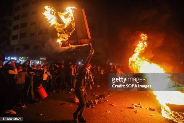 Palestinians burn tires and celebrate in Gaza City after a Palestinian gunman opened fire outside the east Jerusalem synagogue. At least seven...