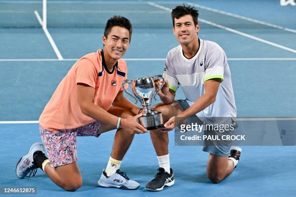 Australia's Rinky Hijikata and Jason Kubler pose with the trophy after victory against Poland's Jan Zielinski and Monaco's Hugo Nys during the men's...