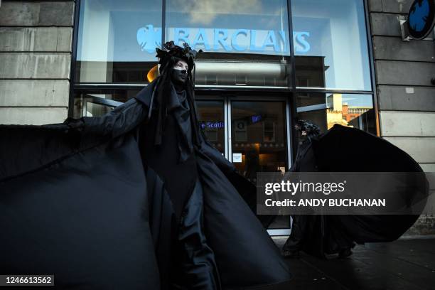 Activists take part in an Extinction Rebellion Scotland protest outside the Barclays Bank branch in Argyle Street in Glasgow on January 28, 2023.