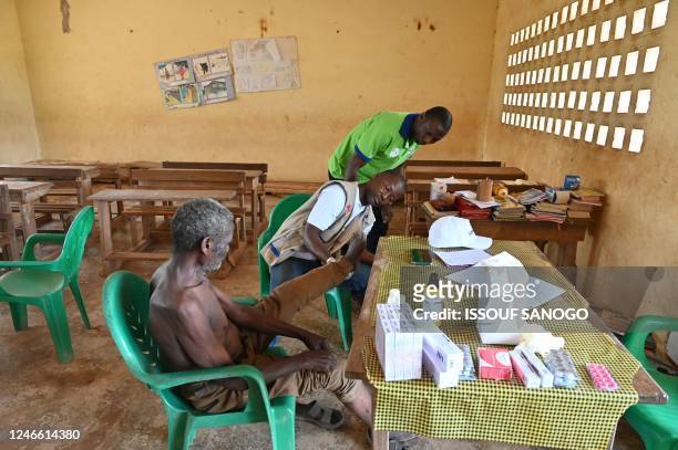 Doctor consults a resident during a leprosy screening campaign in village of Djougbosso, near Adzope, on January 25, 2023. - Listed by the WHO as one...