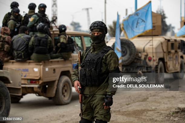 Syrian Kurdish Asayish security forces deploy during a raid against suspected Islamic State group fighters in Raqa, the jihadist group's former...