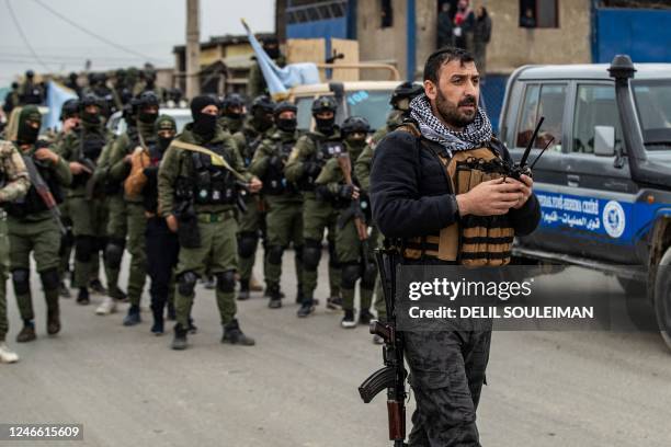 Syrian Kurdish Asayish security forces deploy during a raid against suspected Islamic State group fighters in Raqa, the jihadist group's former...