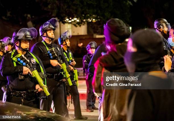 Protesters confront Los Angeles Police officers wearing riot gear near City Hall after crowds became unruly after a vigil for Tyre Nichols near LAPD...