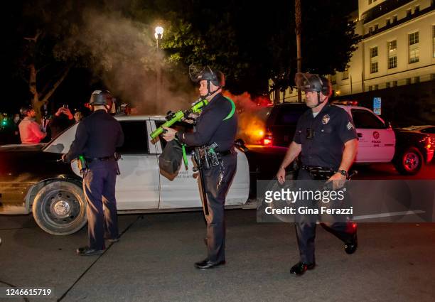 Los Angeles Police officers wearing riot gear keep protesters from advancing on after crowds became unruly after a vigil for Tyre Nichols near LAPD...