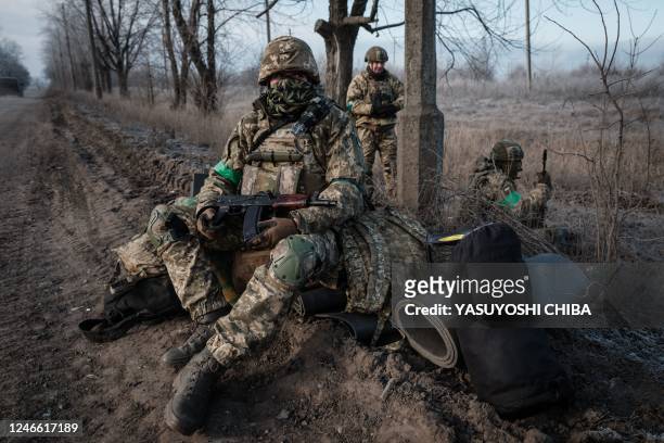 Ukrainian paratrooper Andriy and comrades wait for transport along the road in Chasiv Yar on January 28 amid the Russian invasion of Ukraine.