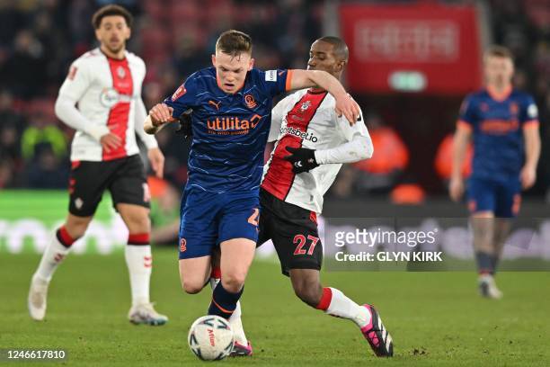 Southampton's French midfielder Ibrahima Diallo is booked for this foul on Blackpool's Irish defender Andy Lyons during the English FA Cup fourth...