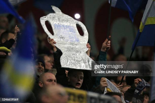 Tinfoil FA Cup is help up by a fan in the crowd ahead of the English FA Cup fourth round football match between Preston North End and Tottenham...