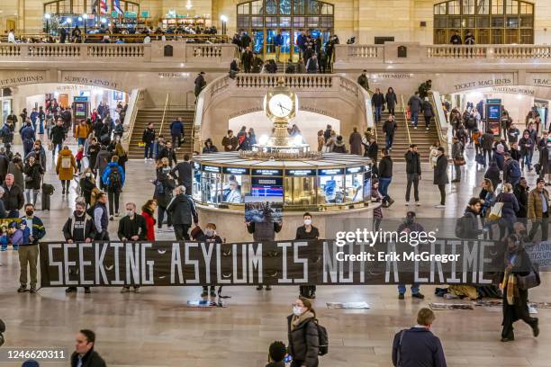 Protesters seen holding a banner reading SEEKING ASYLUM IS NOT A CRIME at the vigil. Members of the activist group Rise and Resist gathered at the...