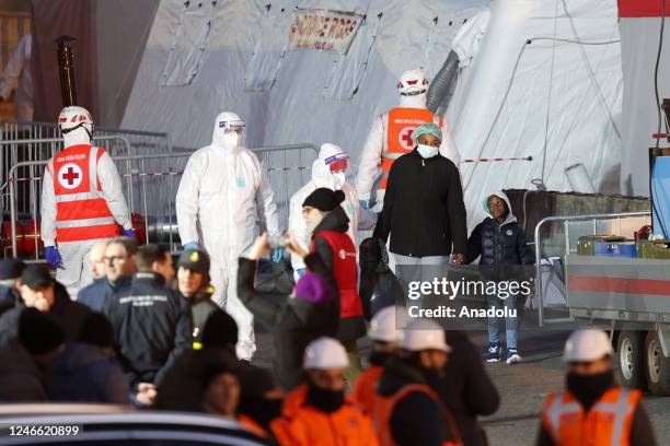 Migrants disembark from the NGO Medecins sans Frontieres Geo Barents ship after it docked at La Spezia harbour, Italy, on January 28, 2023. The Geo...