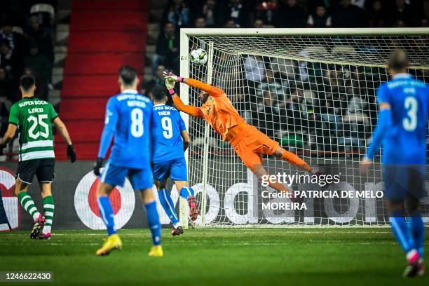 Sporting Lisbon's Spanish goalkeeper Antonio Adan dives for the ball and concedes a goal to FC Porto's Canadian midfielder Stephen Eustaquio during...