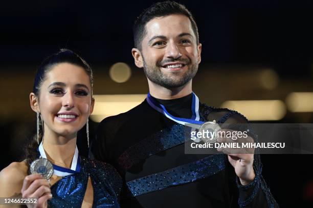 Second placed Britain's Lilah Fear and Lewis Gibson pose with their medals during the victory ceremony after the Ice Dance - Free Dance event of the...