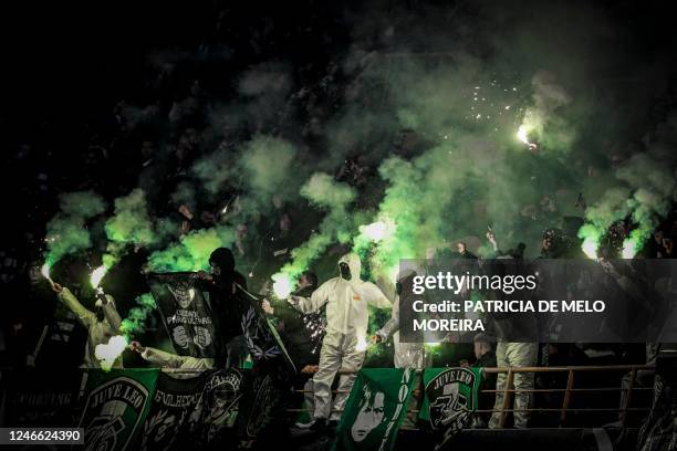 Sporting's supporters light flares during the Portuguese League Cup final football match between Sporting CP and FC Porto at the Dr. Magalhaes Pessoa...