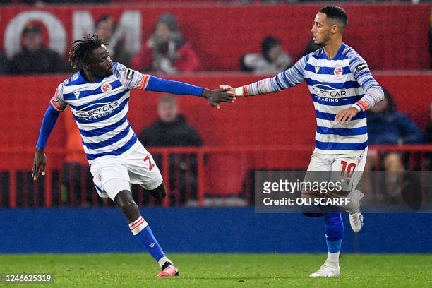 Reading's Senegalese midfielder Amadou Mbengue celebrates with Reading's English midfielder Tom Ince after scoring their first goal during the...