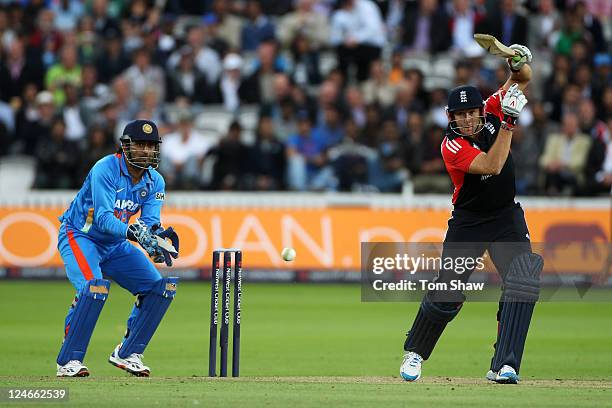 Tim Bresnan of England hits out as MS Dhoni of India watches from behind the stumps during the 4th Natwest One Day International match between...