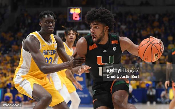 Norchad Omier of the Miami Hurricanes drives to the basket against Federiko Federiko of the Pittsburgh Panthers in the first half during the game at...