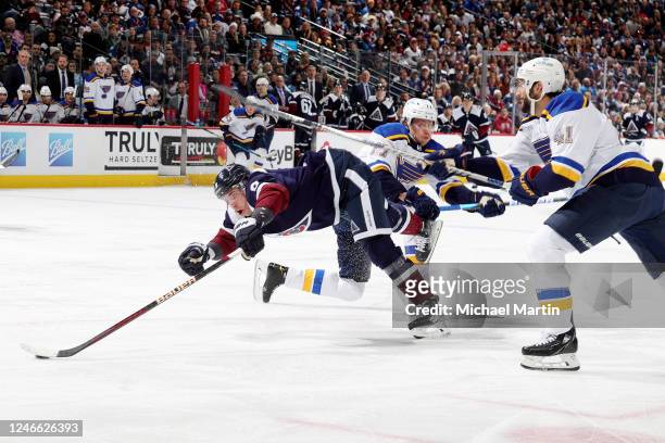 Evan Rodrigues of the Colorado Avalanche skates against Niko Mikkola and Robert Bortuzzo of the St. Louis Blues at Ball Arena on January 28, 2023 in...