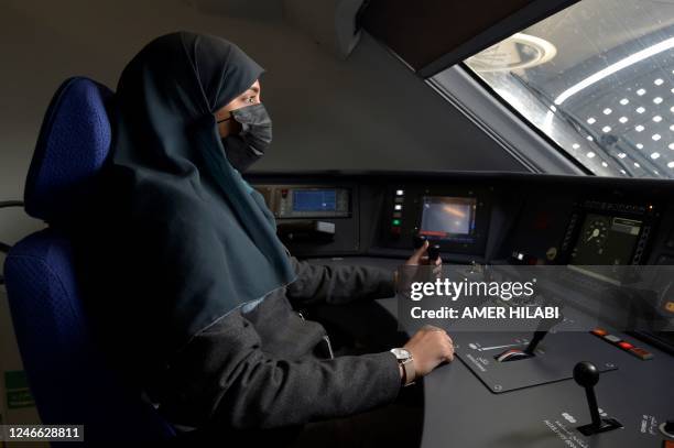 Saudi conductor Raneem Azzouz, drives a high-speed train ferrying pilgrims to Mecca, in Saudi Arabia's Red Sea coastal city of Jeddah, on January 22,...