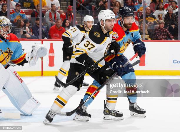 Aaron Ekblad of the Florida Panthers defends against Patrice Bergeron of the Boston Bruins in front of the net during second period action at the FLA...