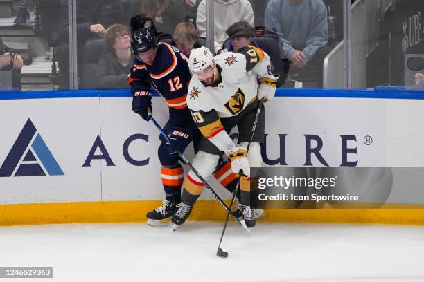 New York Islanders Right Wing Josh Bailey and Las Vegas Golden Knights Center Nicolas Roy battle for the puck during the first period of the National...