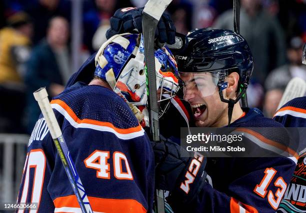 Mathew Barzal of the New York Islanders celebrates with Semyon Varlamov after scoring the game-winning goal against the Vegas Golden Knights during...