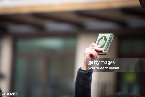 Protestor holds the Quran during the demonstration against the Quran Burning In Sweden. A high representative of the United Nations Alliance of...