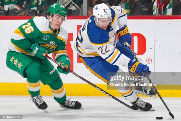 Jack Quinn of the Buffalo Sabres skates with the puck while Connor Dewar of the Minnesota Wild defends during the game at the Xcel Energy Center on...