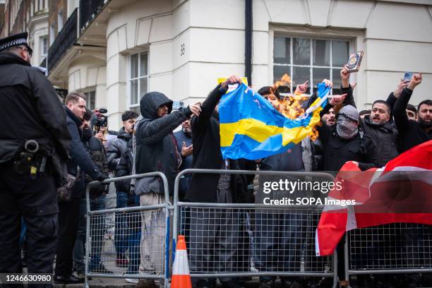 Protestors burn the Swedish flag during the demonstration against the Quran Burning In Sweden. A high representative of the United Nations Alliance...