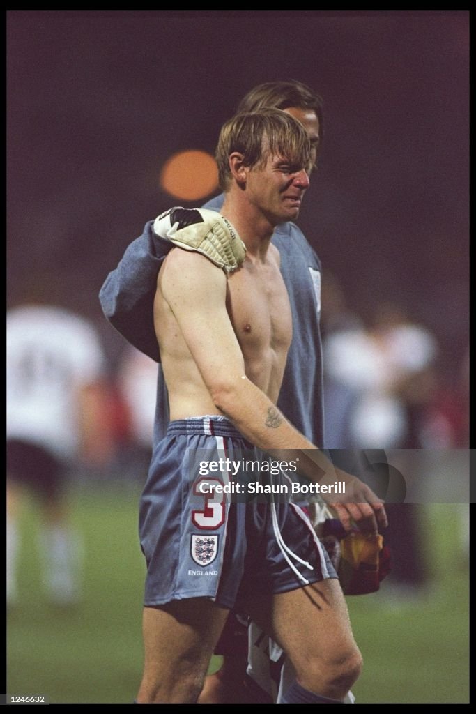 Stuart Pearce of England is consoled