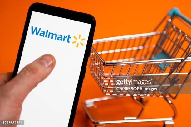 In this photo illustration a Walmart logo seen displayed on a smartphone.