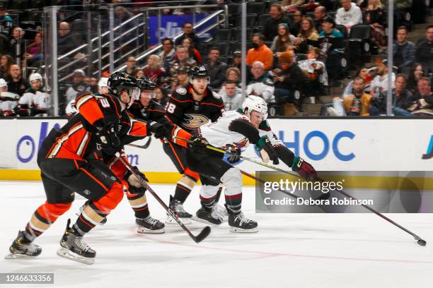 Christian Fischer of the Arizona Coyotes reaches for the puck with pressure from Anaheim Ducks during the second period at Honda Center on January...