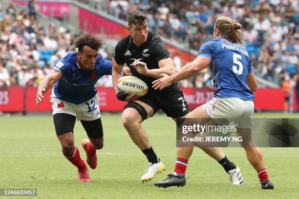 Sam Dickson of New Zealand fends off a tackle in the match between New Zealand and France during the World Rugby Sevens series match at the Allianz...