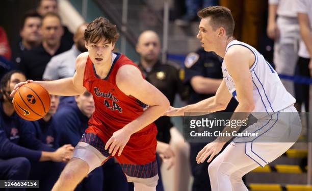 Alex Ducas of the Saint Marys Gaels pushes the ball past Spencer Johnson of the Brigham Young Cougars during the second half of their game January...