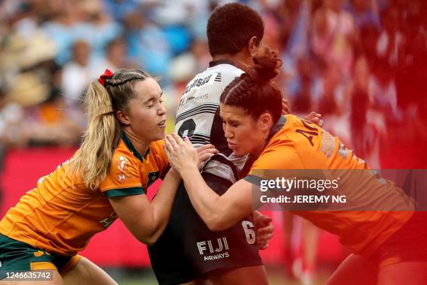 Australia's Charlotte Caslick tackles Fiji's Reapi Ulunisau during the World Rugby Women's Sevens series match between Australia and Fiji at the...